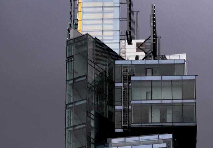 A tall building with many windows and stairs.